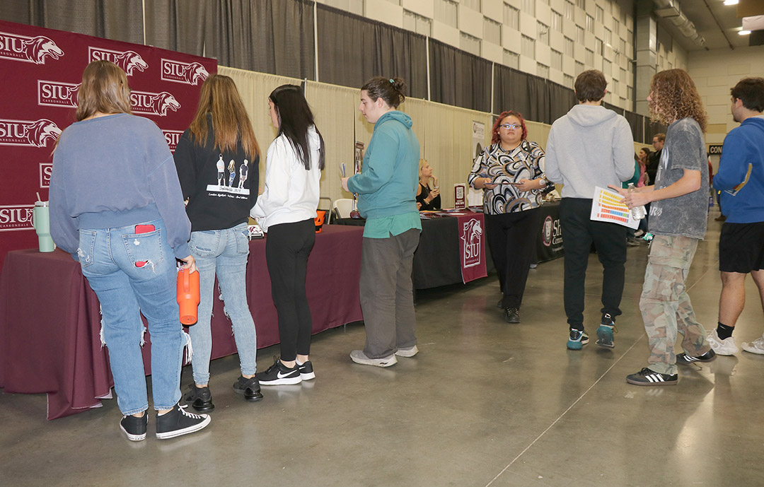 Staff from Southern Illinois University speak with students at the career fair.