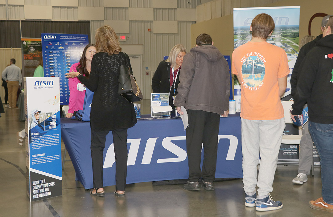 Students learn about career opportunities at the AISIN booth.