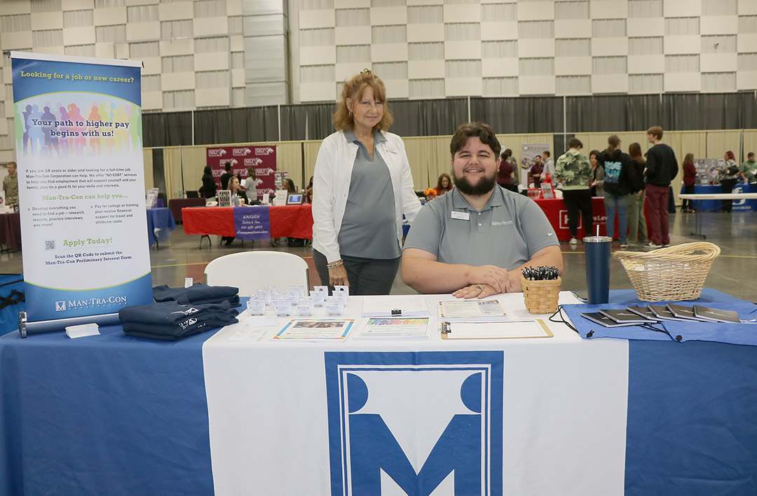 Youth Program Coordinator Jo Dene Kern and Career Specialist Justin Dodd welcome students to the ManTraCon table.