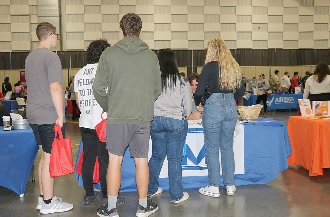 Youth Program Coordinator Jo Dene Kern and Career Specialist Justin Dodd speak with students about Man-Tra-Con services.