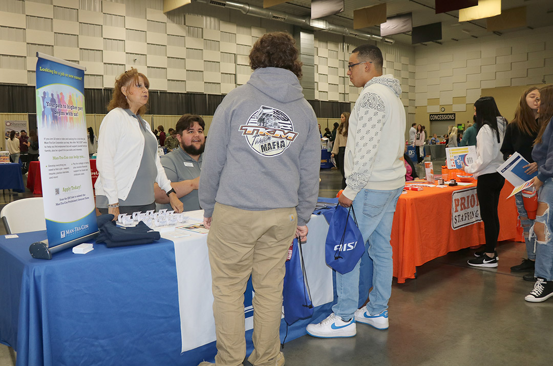 Youth Program Coordinator Jo Dene Kern explains Man-Tra-Con services for young adults to students.