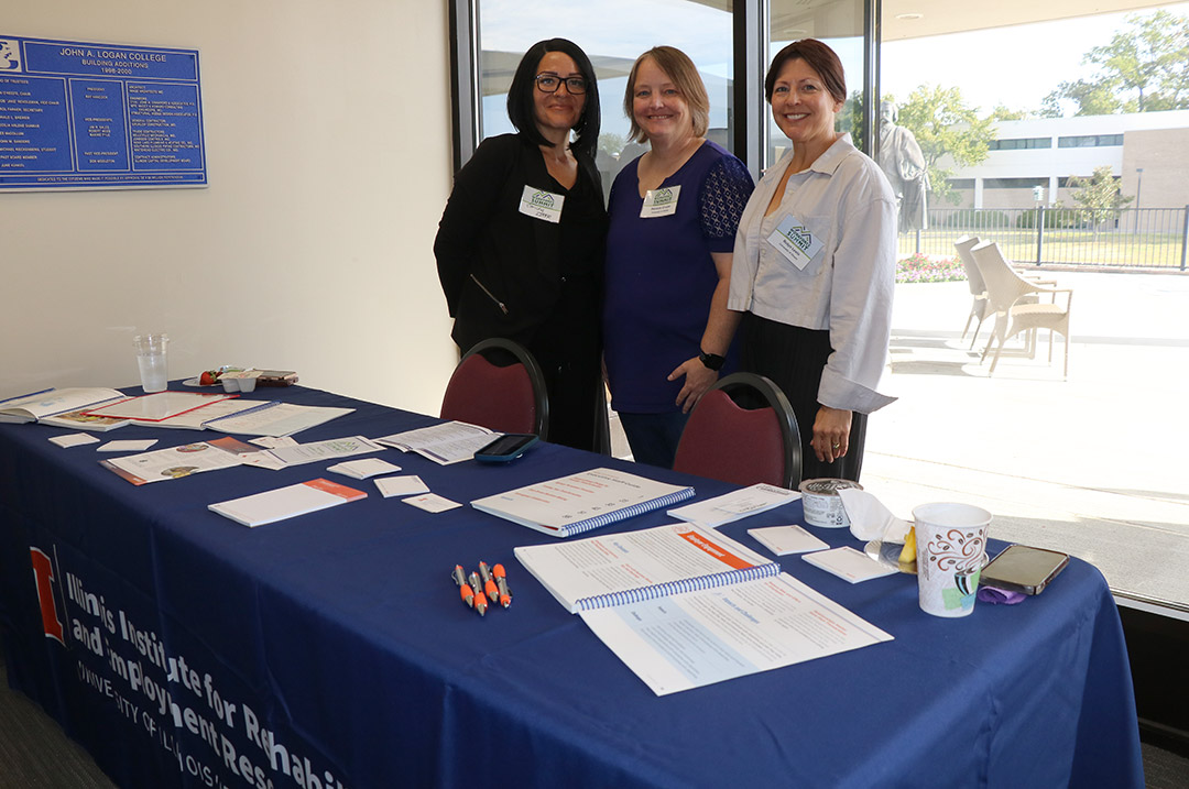 Left to right: Concha Lirer, Danielle Cruzan, and Robyn Lewis from University of Illinois Urbana-Champaign greet attendees.